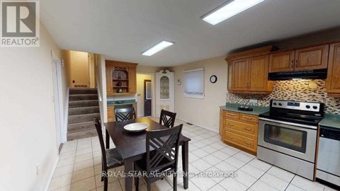 A kitchen with a table and chairs in the middle of the room.
