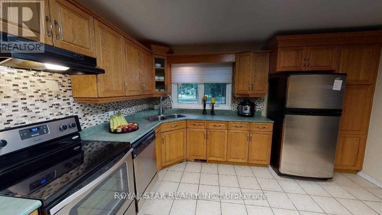 A kitchen with wooden cabinets and a black stove top oven.