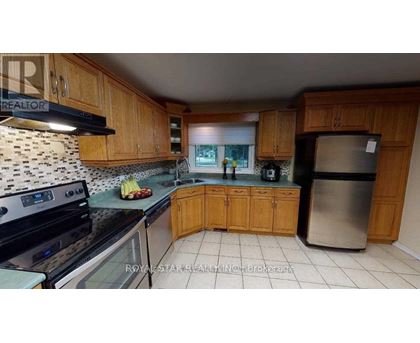 A kitchen with wooden cabinets and a black stove top oven.