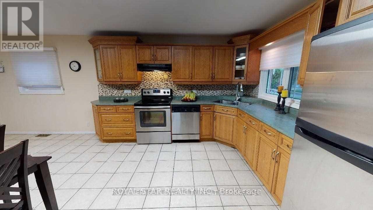 A kitchen with wooden cabinets and a stove top oven.