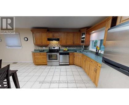 A kitchen with wooden cabinets and a stove top oven.