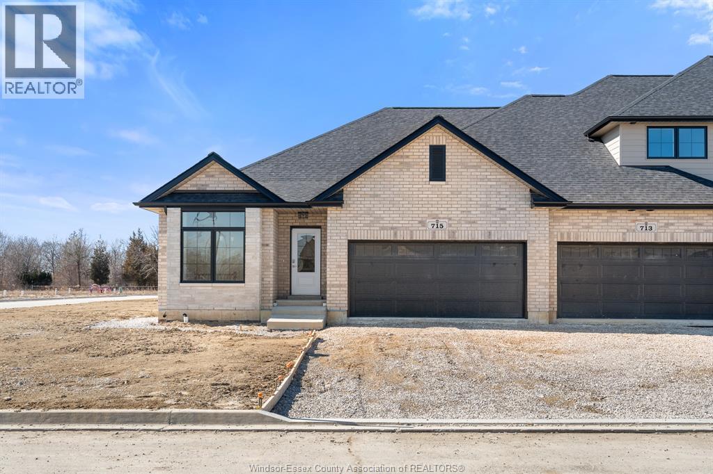 A house with a brown brick exterior and a black roof is for sale.