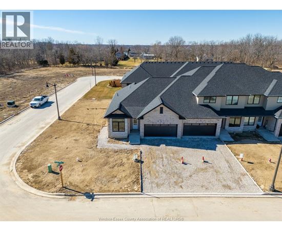 A large house with a driveway in front of it.