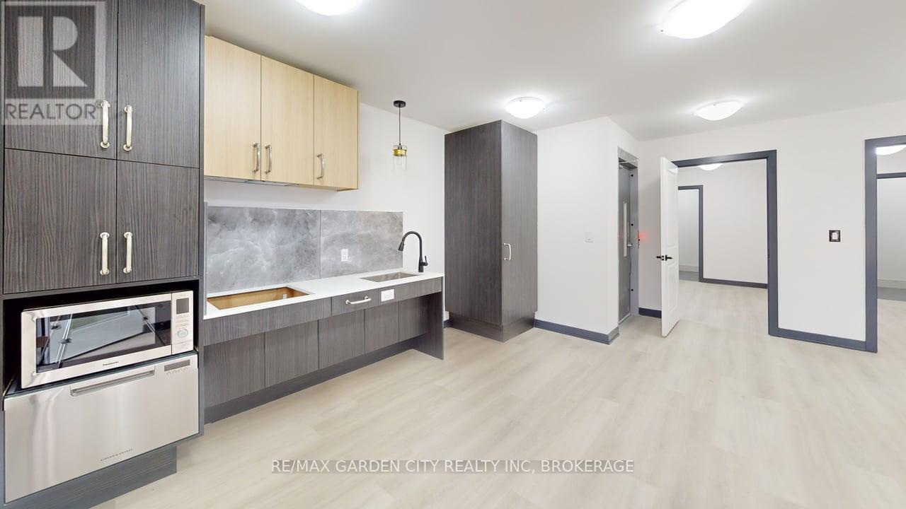 A modern kitchen with a stainless steel oven and wooden countertops.