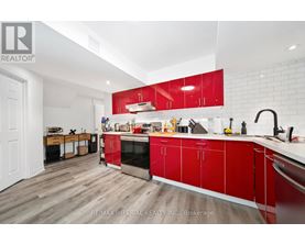 A kitchen with red cabinets and a white countertop.