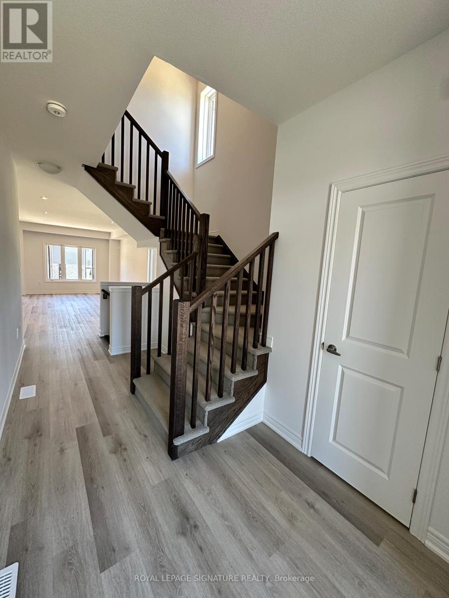 A wooden staircase with a white door on the side.