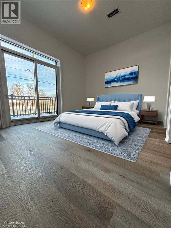 A bedroom with a large bed and a painting on the wall.