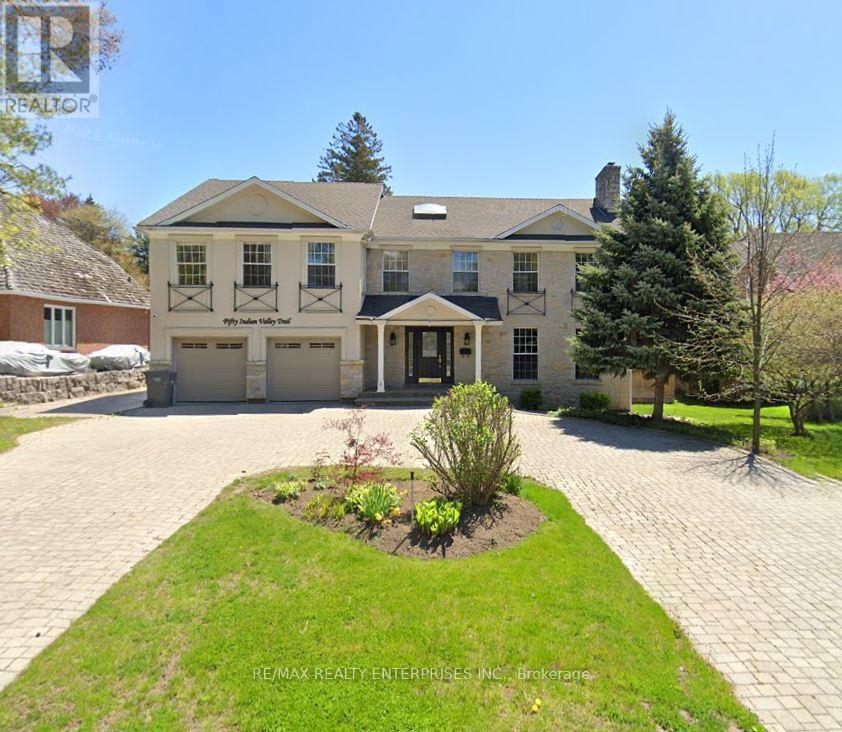 A large house with a driveway in front of it.