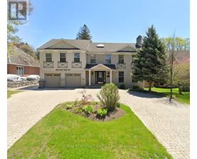 A large house with a driveway in front of it.