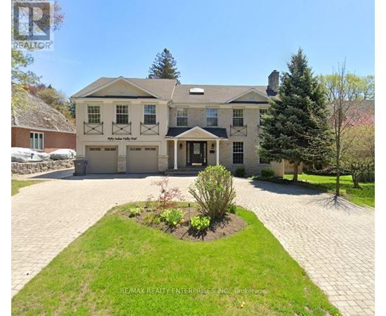 A large house with a driveway in front of it.