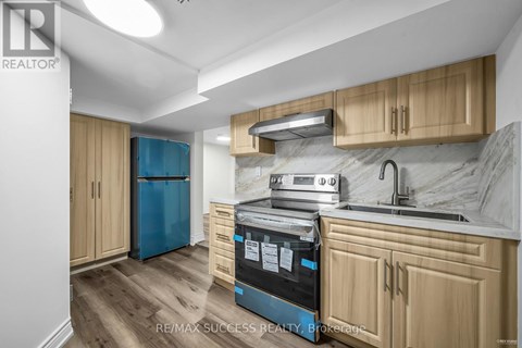 A kitchen with wooden cabinets and a blue fridge.