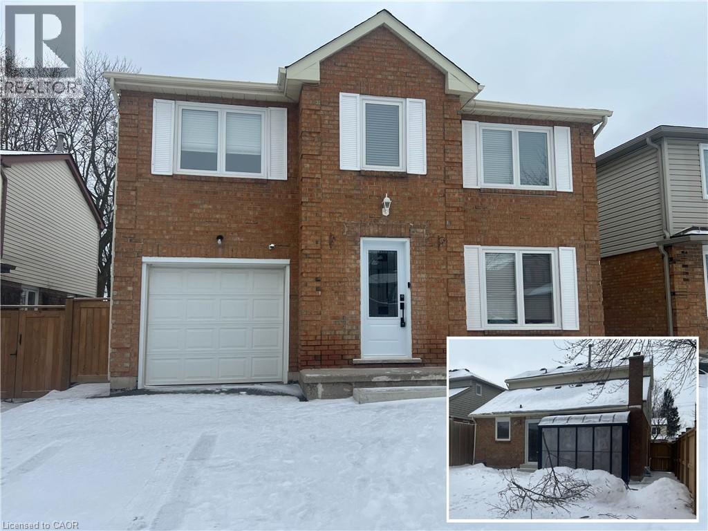 A house with a white garage door and a snow-covered ground.