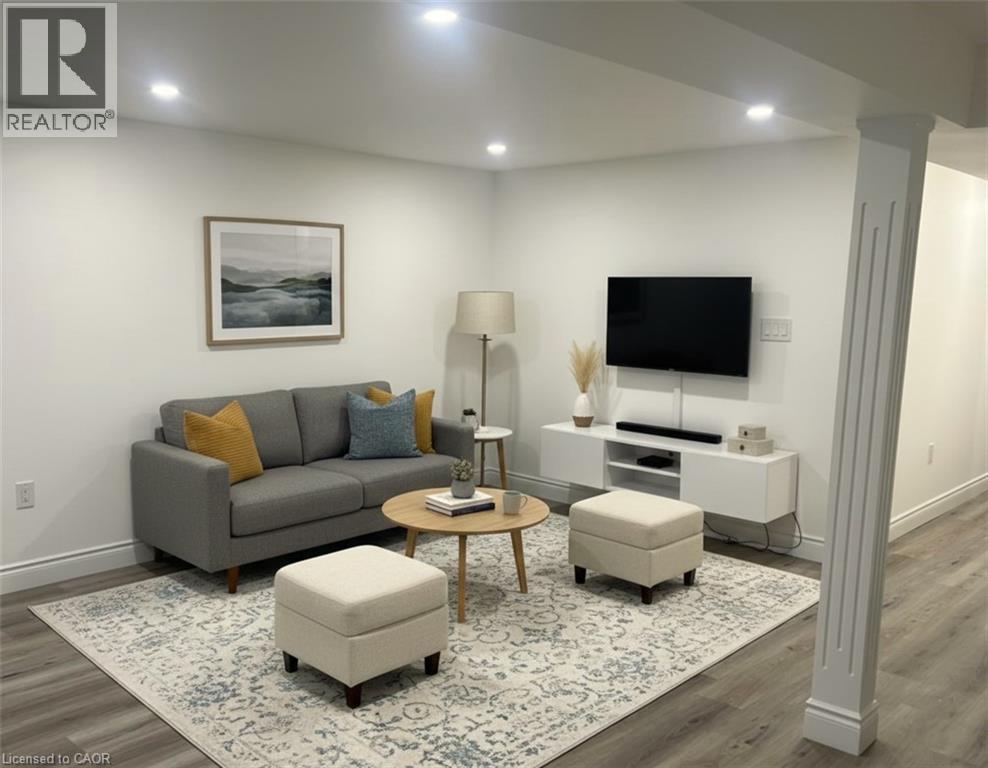 A living room with a grey couch, a coffee table, a lamp, a TV, and a framed picture on the wall.