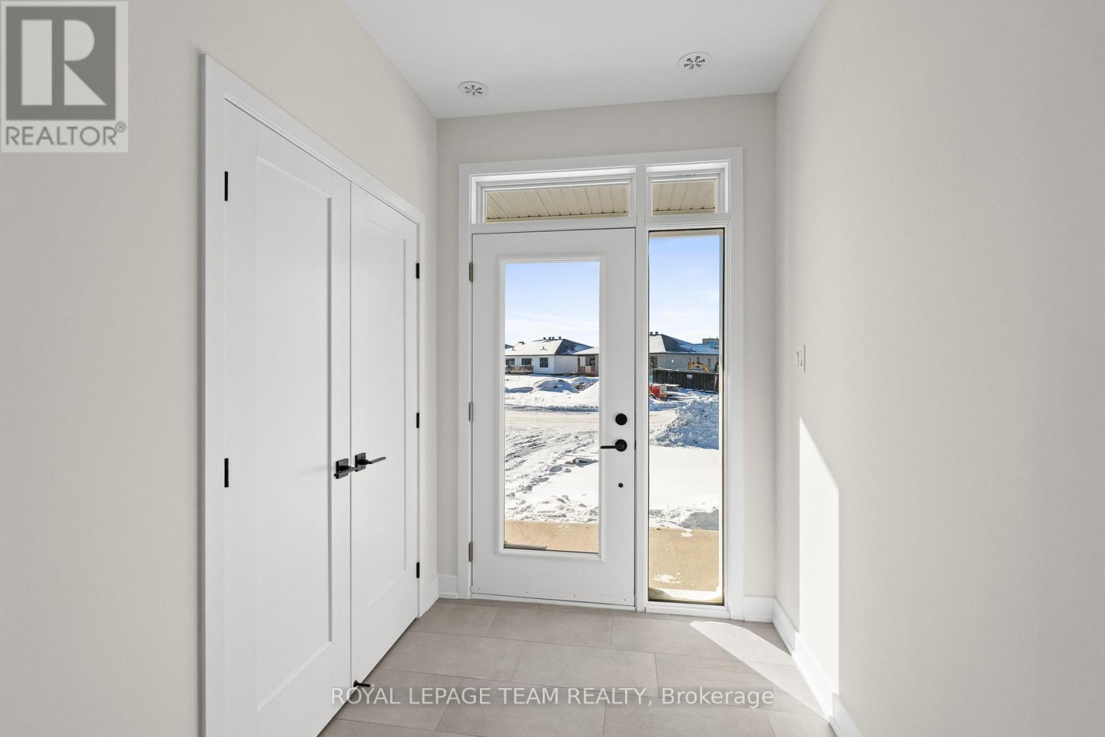 A white door with a glass window is in a room with white walls.
