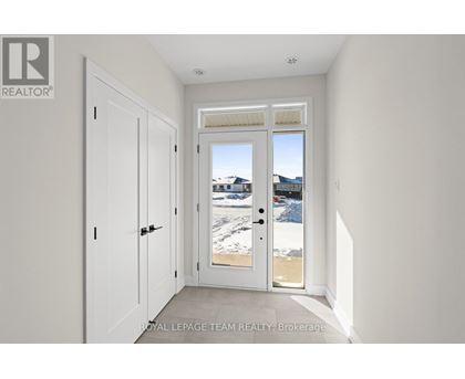 A white door with a glass window is in a room with white walls.