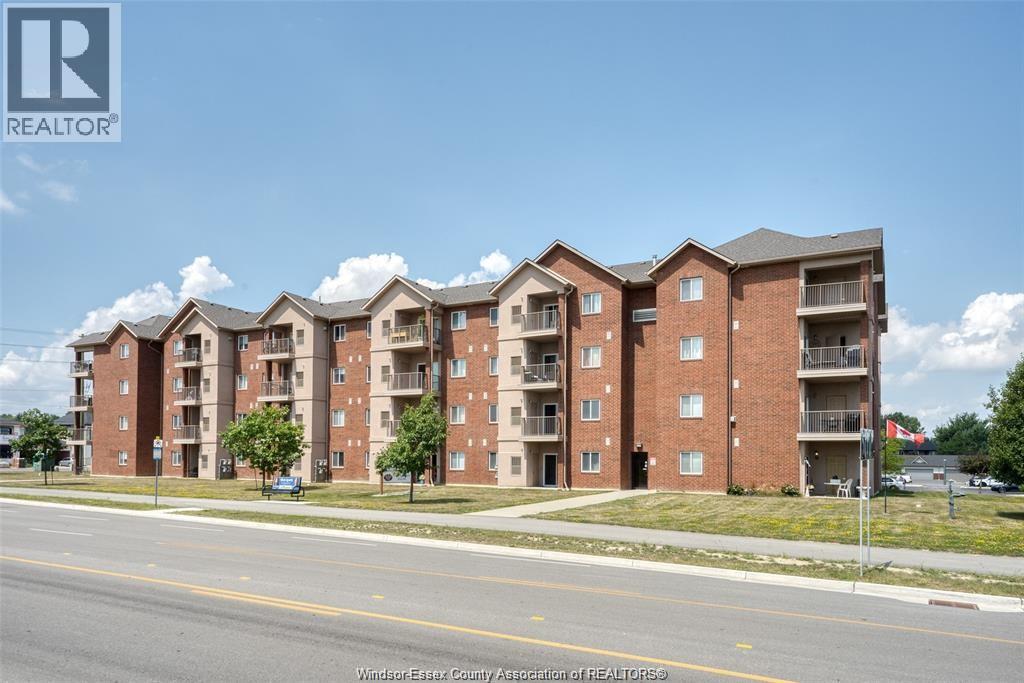 A large brick apartment building with a blue sky in the background.