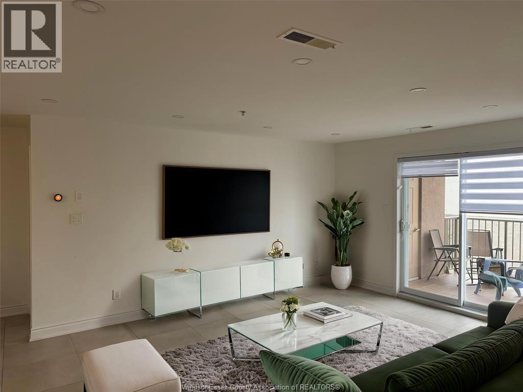 A living room with a flat screen TV mounted on the wall.