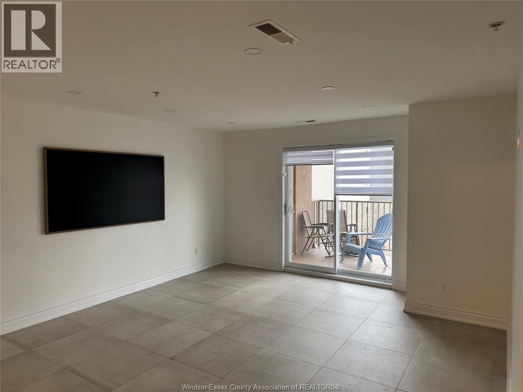 A living room with a flat screen TV mounted on the wall.
