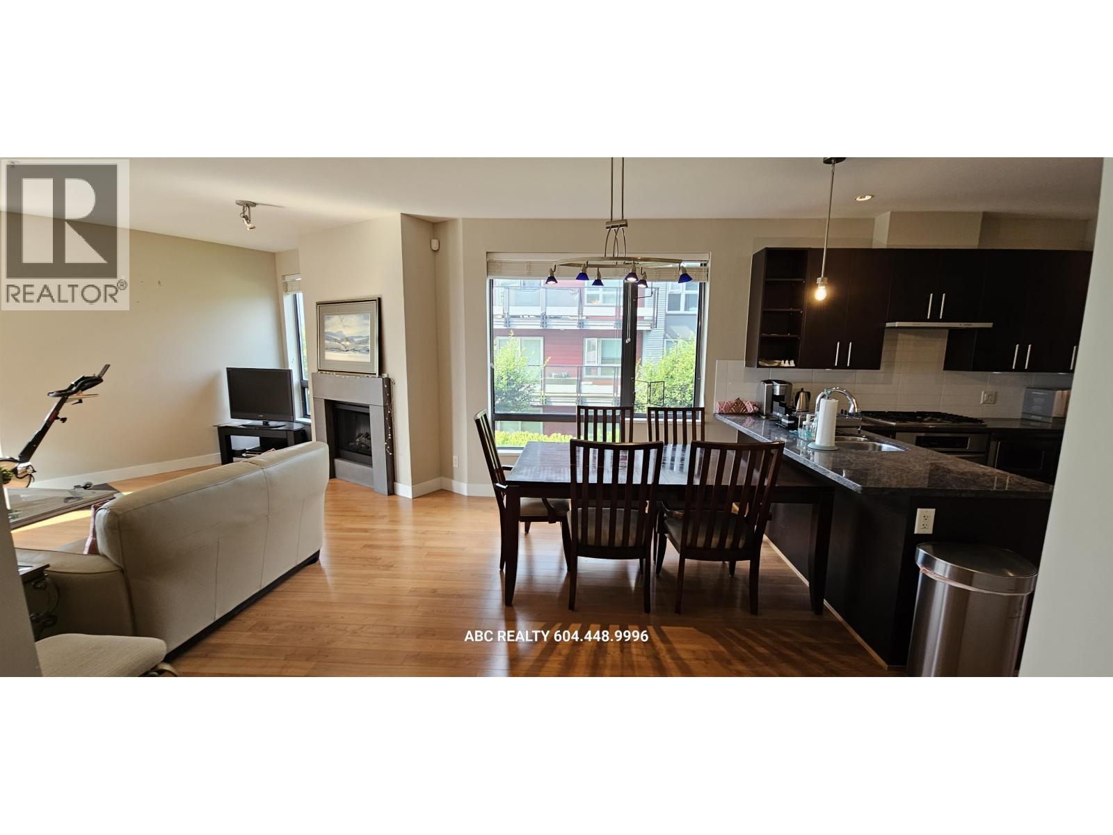 A modern kitchen with a dining table and chairs.