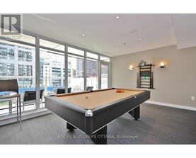 A pool table in a room with a view of the city.