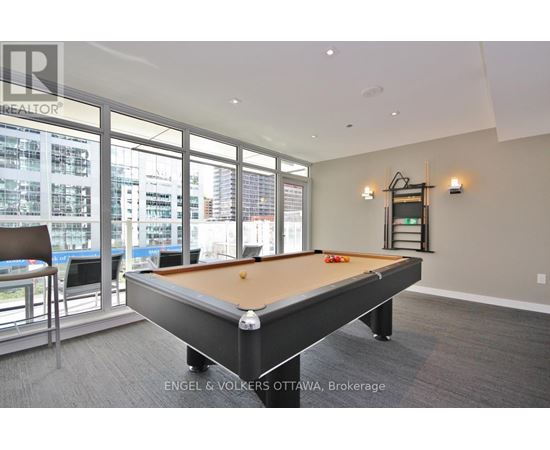 A pool table in a room with a view of the city.