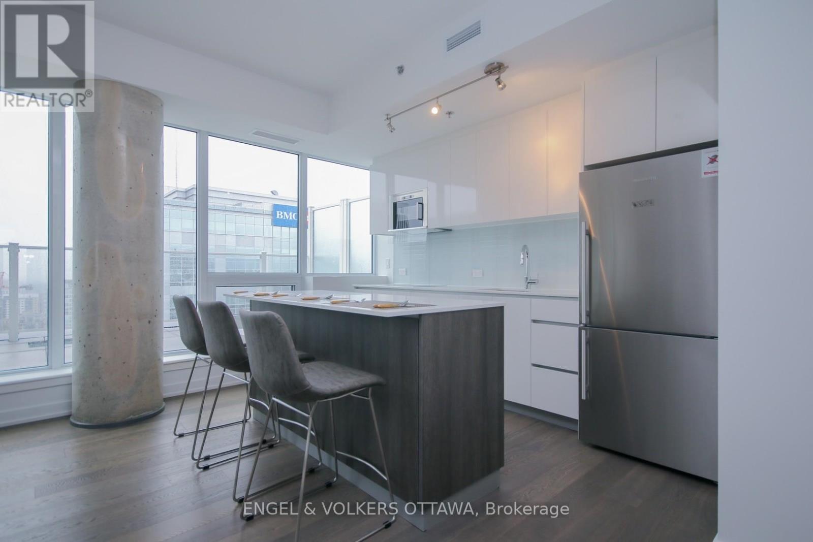 A modern kitchen with a dining table and chairs.