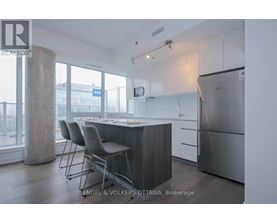 A modern kitchen with a dining table and chairs.
