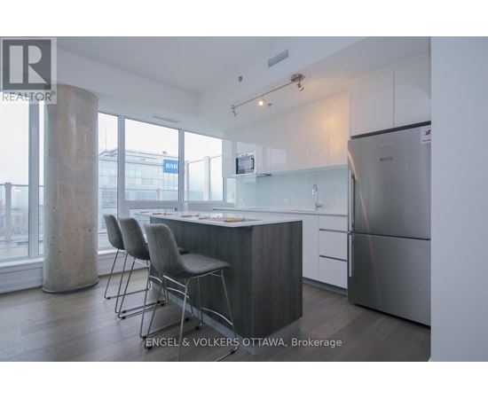 A modern kitchen with a dining table and chairs.