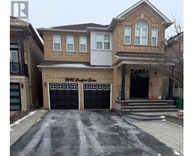 A two-story brick house with a black garage door and a white door.
