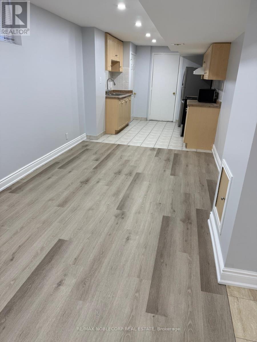 A room with wooden flooring and a white door.