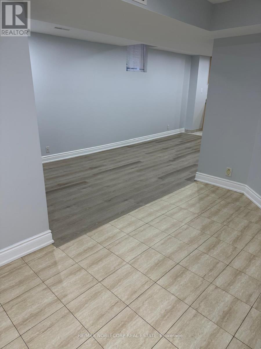 A room with a tile floor and a window with blinds.