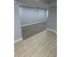 A room with a tile floor and a window with blinds.
