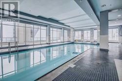 A large indoor swimming pool with a glass bottom.