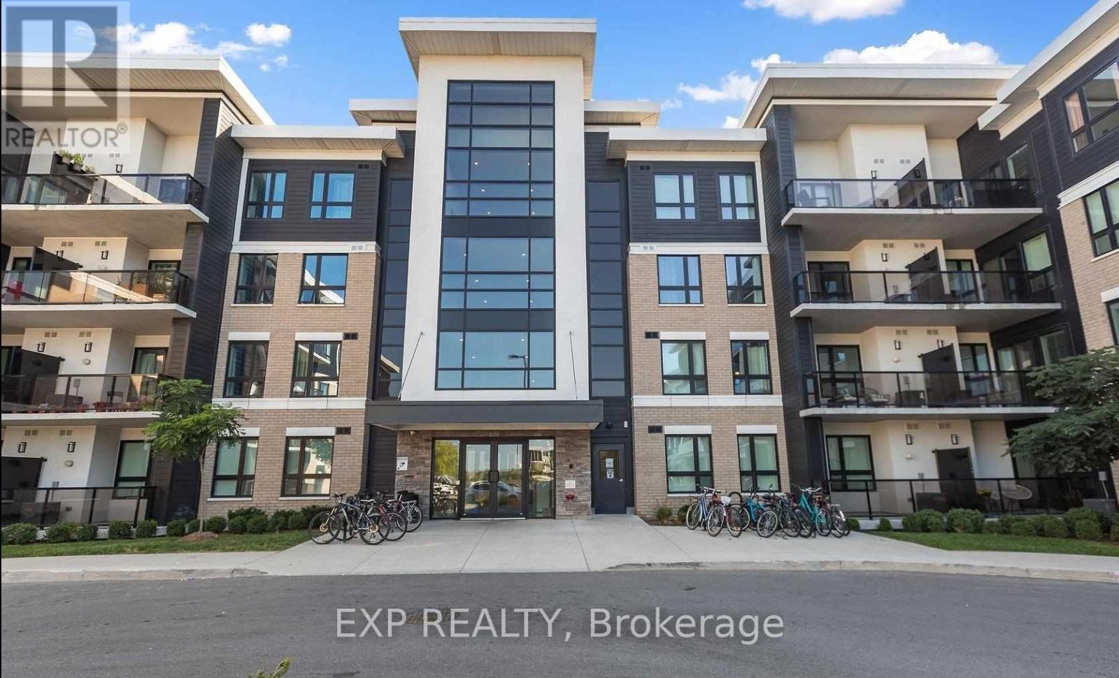 A modern apartment building with a glass entrance and bicycles parked in front.