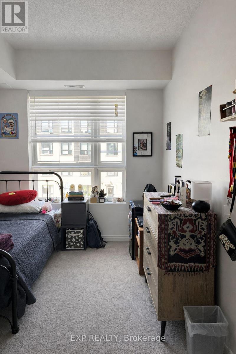 A bedroom with a bed, desk, and window with blinds.