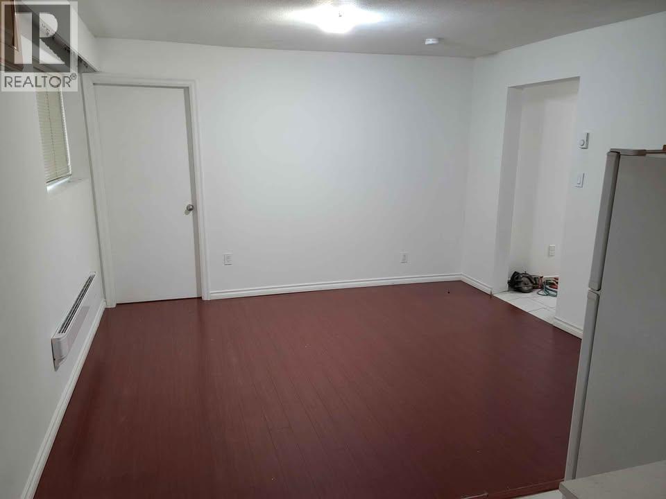 A room with a wooden floor and white walls.