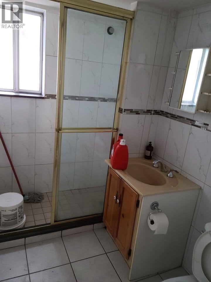A bathroom with a sink, toilet, and a shower with a glass door.