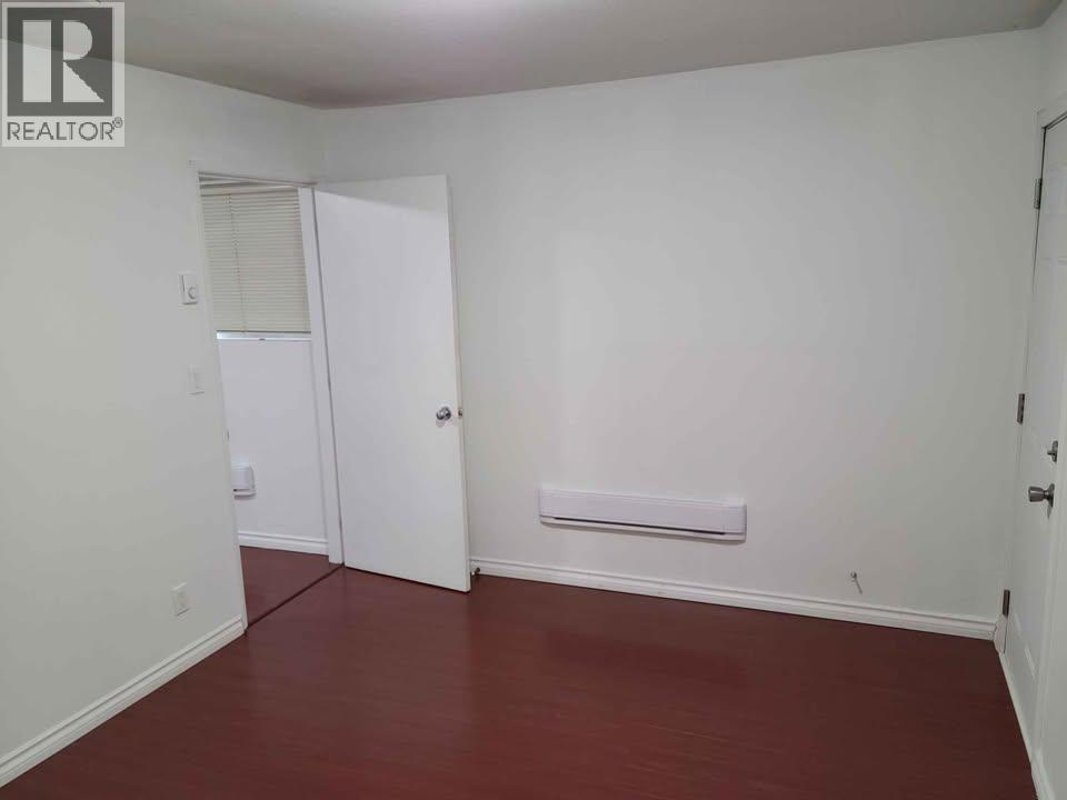 A room with white walls and a red floor.