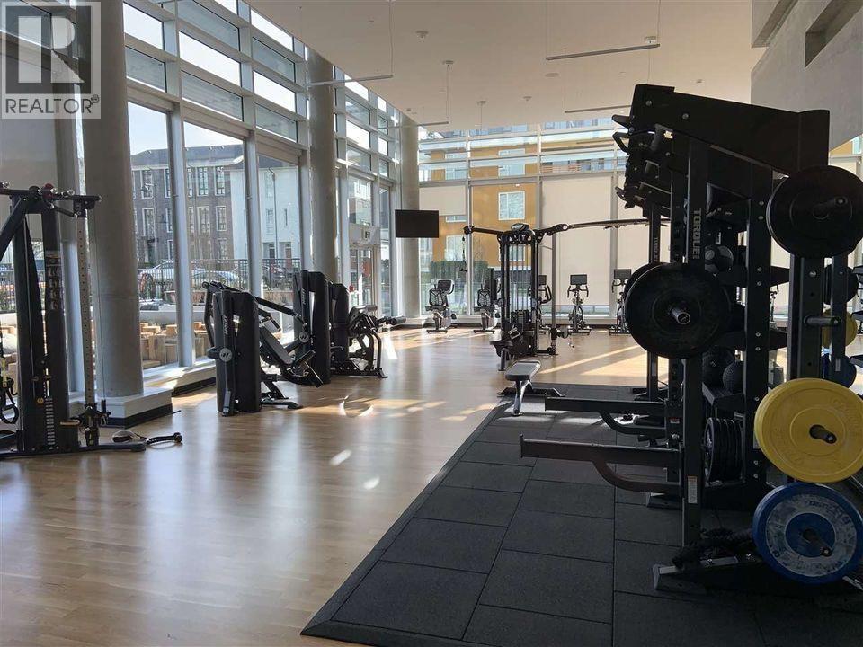 A gym with a variety of equipment including weights and treadmills.