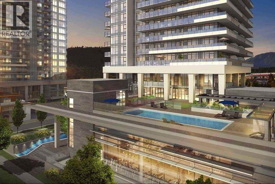 A modern building with a pool in front of it.