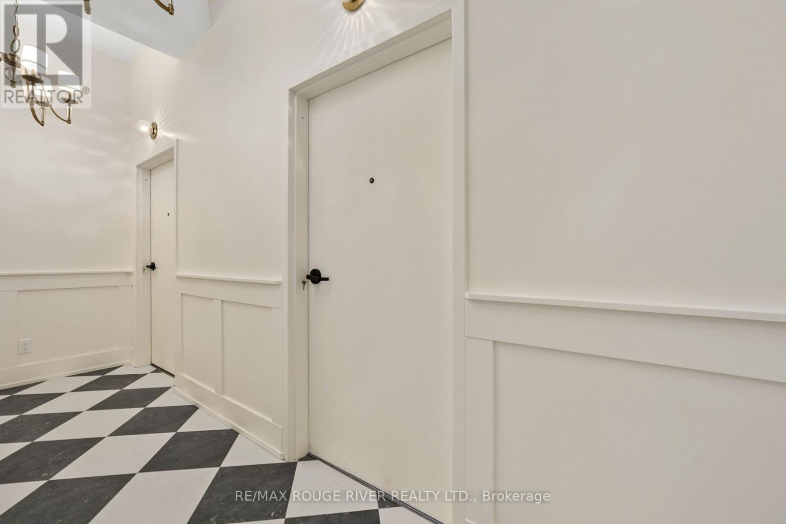 A hallway with a black and white checkered floor.