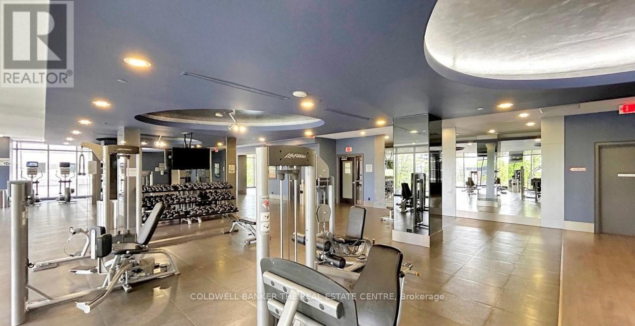 A gym with a variety of equipment including treadmills, weights and exercise machines.