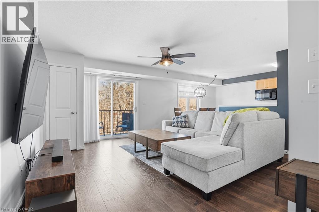 A living room with a white couch and a wooden coffee table.
