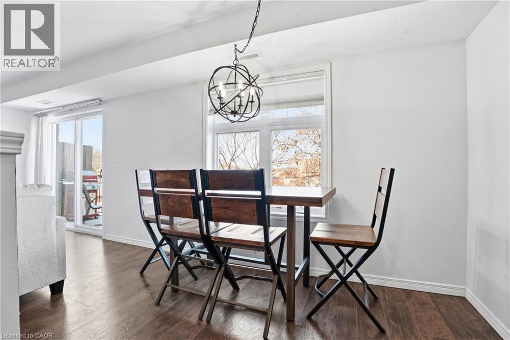 A dining room with a table and chairs.