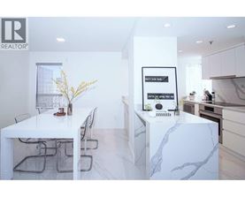 A white dining table with chairs and a framed picture on the wall.