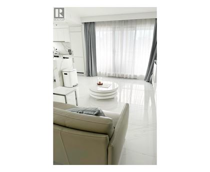A modern living room with a grey sofa and a coffee table.