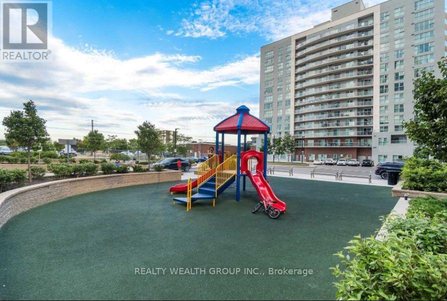 A playground with a red slide and a blue and yellow structure.