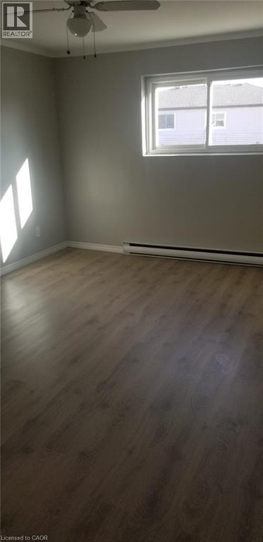 A room with a ceiling fan and a window.