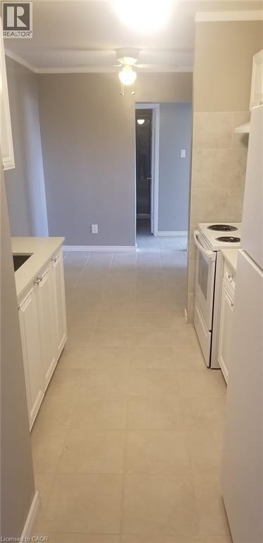 A kitchen with white appliances and cabinets.