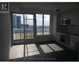 A kitchen with a view of the city through the windows.